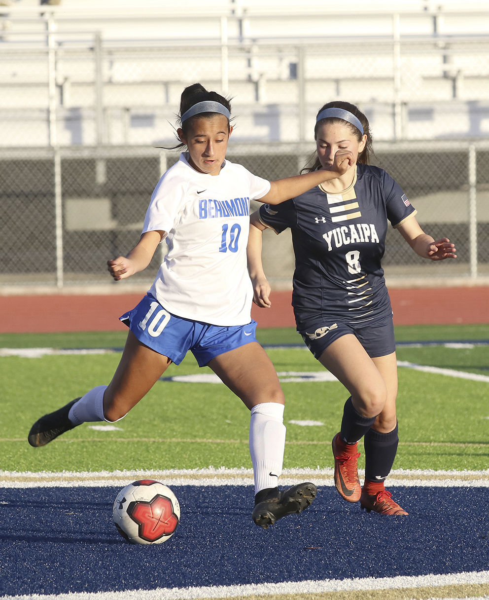 Cougar Melainie Murillo kicks the ball away from T bird Thalia Avalos